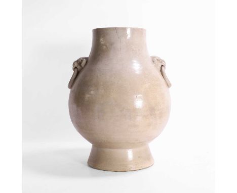 A Chinese celadon-glazed vase, Qing dynasty (1644-1911), the pear-shaped body rising from a tall spreading foot, flanked by t