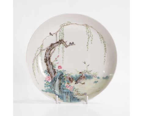 A Chinese famille rose saucer, 20th century, of circular form, painted with ducks by a rock, under a willow tree, the reverse