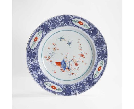 A Chinese wucai plate, Kangxi (1662-1722), painted in the Kakiemon style, with quail and other birds by a blossoming prunus t