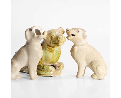 A Chinese sancai-glazed dog, Ming dynasty (1368-1644), recumbent, covered with green, cream and amber glazes, 10cm long, and 