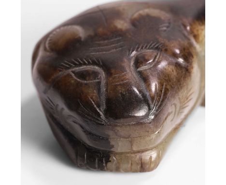 A Chinese jade carving, late Qing dynasty, of a recumbent tiger, 8.5cm long, wood stand (2)清晚期 玉雕虎把件 连木底座Condition ReportSmal