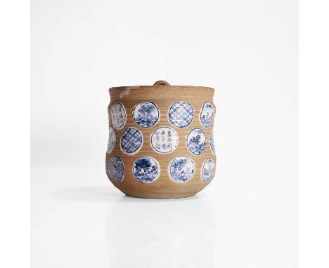 A Japanese mizusashi water jar, 19th century, the ovoid waisted body with a ribbed surface, painted with roundels of landscap