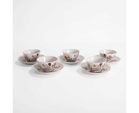 A collection of five Chinese famille rose cups and saucers, Qing dynasty (1644-1911), each painted with a cockerel standing o