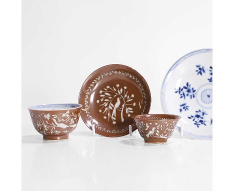 Two pairs of Chinese cups and saucers, Qing dynasty (1644-1911), each carved with birds and flowers against a cafe-au-lait gr