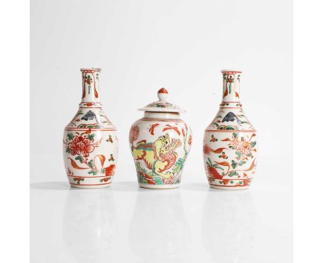 A pair of Chinese wucai vases, Kangxi (1662-1722), each of tapering form, painted with a phoenix standing on a rock amongst p