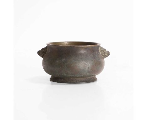A Chinese bronze incense burner, Qing dynasty (1644-1911), the compressed globular body supported on a flared circular foot, 