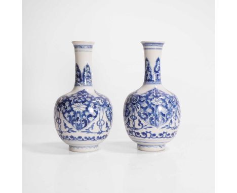 A pair of Chinese blue and white vases, Kangxi (1662-1722), each of ovoid form, painted with scrolling lotus in shaped panels