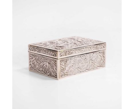 A Chinese silver box, late Qing dynasty, of rectangular form, the hinged cover decorated with a dragon amongst clouds, the si