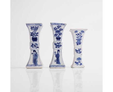 Three Chinese blue and white gu vases, Kangxi (1662-1722), each of slender elongated square form, rising from an everted foot
