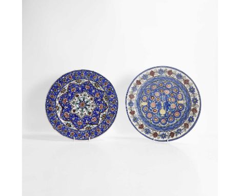A Qajar glazed pottery dish, 19th century, decorated in greens, blues, pinks and cream, with a medallion centred with a flowe
