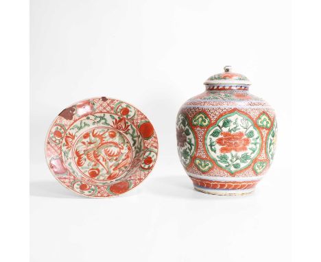 A Chinese wucai jar, Kangxi (1662-1722), of ovoid form, painted with peony in shaped panels against a diapered ground, the co