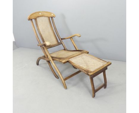 A vintage teak and cane panelled folding steamer lounge chair. 