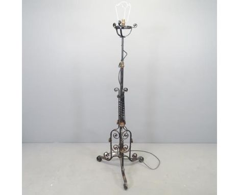 A wrought iron black painted telescopic standard lamp. H - 140cm. 