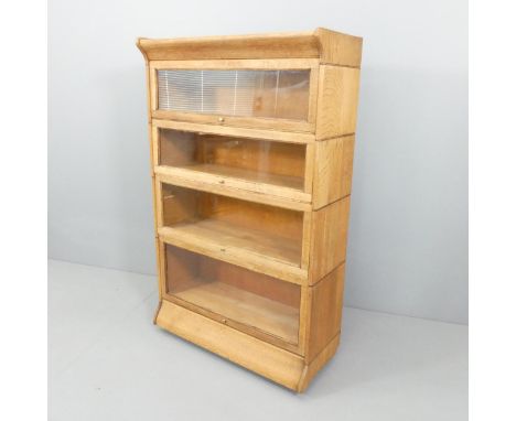 An oak 4-shelf Globe Wernicke style bookcase in one section.  86x141x36cm.Sections have been attached and do not come apart f