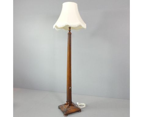 A 1920s oak standard lamp, with platform base. Height to bayonet 160cm. 