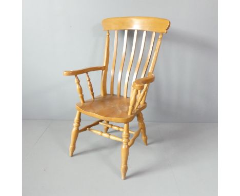 A light oak Windsor kitchen armchair. 