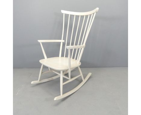 A white painted Windsor stick back rocking chair. 