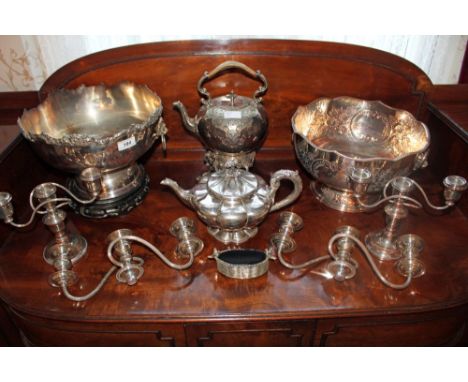 Two silver plated spirit kettles on stands, two silver plated punch bowls, plated candelabra and assorted plated cutlery 