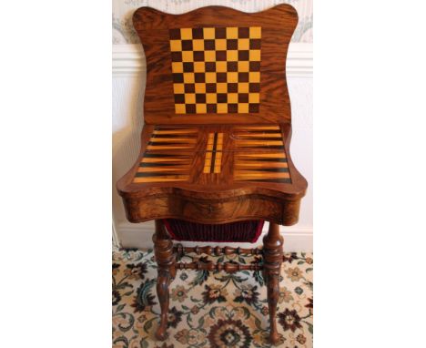 Victorian figured walnut games / sewing table of shaped outline, the fold-over top with marquetry inlaid playing surfaces abo