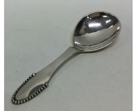 GEORG JENSEN: A stylish silver caddy spoon of textured form. Approx. 30 grams. Est. £40 - £60.