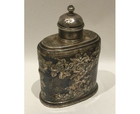 An unusual Georgian silver tea caddy attractively decorated with flowers and leaves to lift-off cover. Apparently unmarked. A