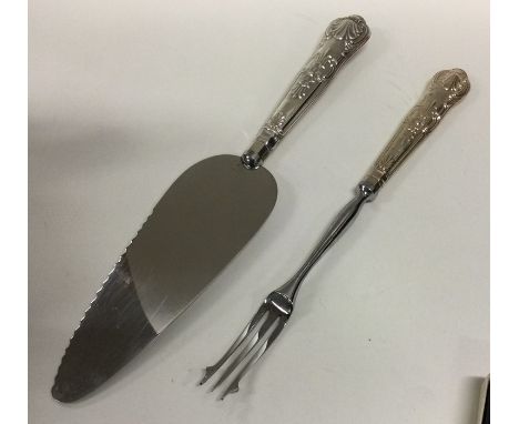 A Kings' pattern silver mounted cake slice together with a pickle fork. Various dates and makers. Approx. 121 grams.  Est. £1