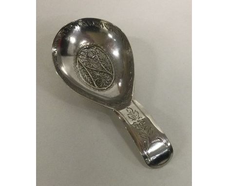 A heavy unusual bright cut silver caddy spoon with filigree centre. Birmingham. By Samuel Pemberton. Approx. 6 grams. Est. £1