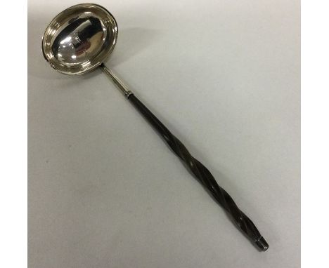 A George III silver toddy ladle with whalebone handle. London 1803. Approx. 17 grams. Est. £25 - £35.
