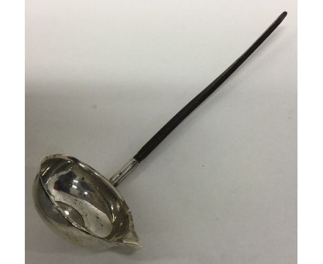 A Georgian silver toddy ladle with coin centre and whalebone handle. Approx. 24 grams. Est. £20 - £30.