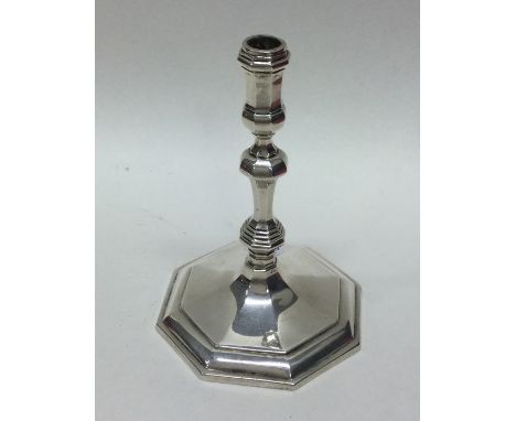 A heavy octagonal cast silver taper stick. London 1963. By Payne &amp; Son. Approx. 165 grams. Est. £150 - £200.