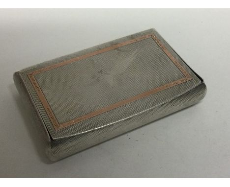 A large engine turned silver table snuff box with gold overlay. London 1958. By Reid &amp; Sons. Approx. 130 grams. Est. £100