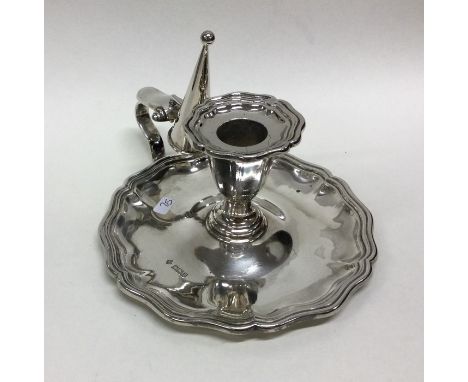 An Edwardian silver chamber stick together with matching extinguisher. Sheffield 1907.  By Martin Ball.  Approx. 241 grams. E