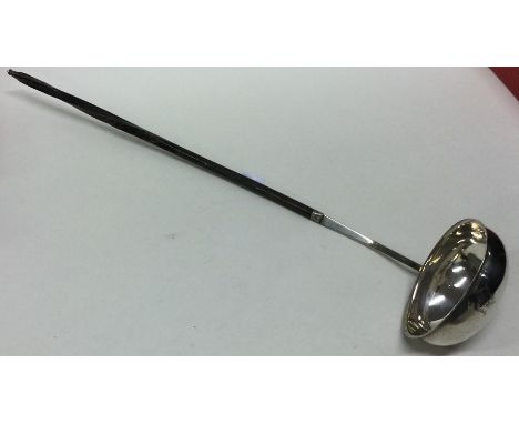 A Georgian silver and whalebone toddy ladle. Approx. 28 grams. Est. £25 - £35.