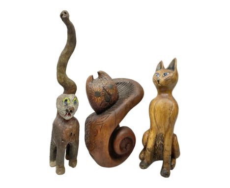 Helen Skelton (British 1933 – 2023): Three carved wooden abstract sculptures, each modelled as a cat, with carved or painted 