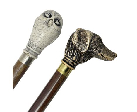 Two walking sticks, the first example with pommel modelled as an owl, the second example with pommel modelled as a hunting do