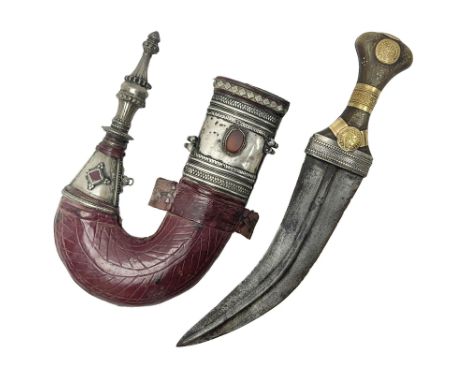 Eastern Jambiya, the 20cm double edge steel blade with raised medial ridge, waisted grip with pique work; in leather scabbard