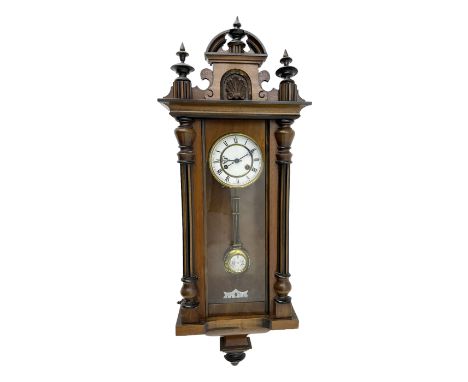 German - late19th century walnut and ebonised Vienna style wall clock, with a carved pediment and finials, fully glazed door 