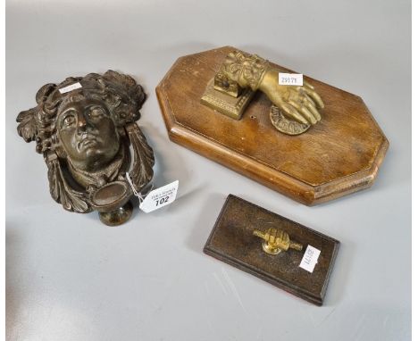 Vintage brass door knocker in the form of a hand on wooden moulded base. Together with another brass door knocker in the form