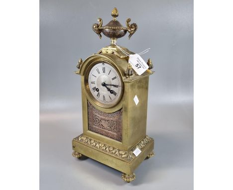 19th century yellow metal mantle clock, having silvered Roman chapter ring, urn finial and French brass drum movement strikin