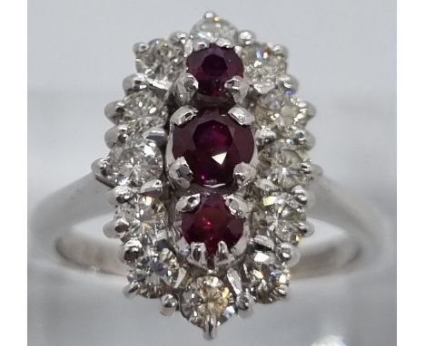 18ct white gold ring of twelve diamonds and three rubies. 7.4g approx. Size N1/2. (B.P. 21% + VAT)  General condition: no sto