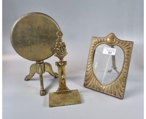 Brass trivet in the form of a snap top pedestal table, a repoussé brass picture frame and brass watch holder with 'The Reveng