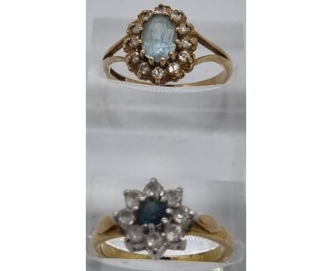 9ct gold blue and clear stone cluster dress ring. 2.3g approx.  Size O, together with a gold plated flowerhead ring.  (2)   (