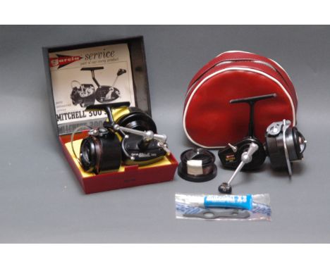 2 Garcia Mitchell fixed spool reels, 300 with original box, instructions and spare spool, and 325 with spare spool, oil, span