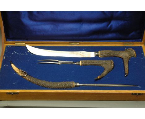 19th century carving set, large form, with stags antler handles, knife and fork engraved "J.P. Langley 1836", blade marked "P