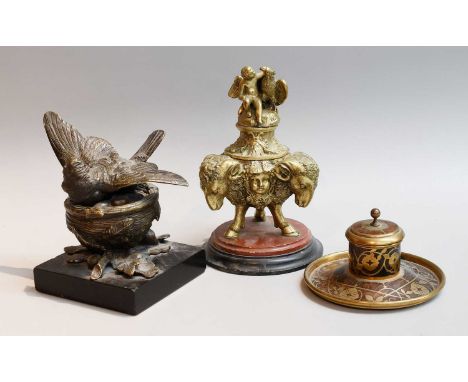 A French Gilt Bronze Inkwell, 19th century, the cover surmounted with a winged putti and eagle, the base formed as three ram 