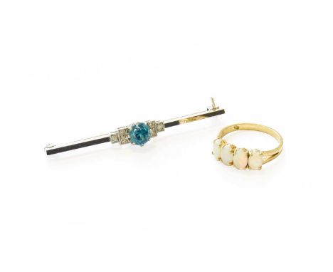 A Blue Zircon and Diamond Brooch, the round cut blue zircon in white claw settings, flanked by trios of eight-cut diamonds in