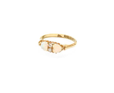 An 18 Carat Gold Opal and Diamond Ring, two heart shaped opals spaced by a pair of old cut diamonds, in yellow claw settings,