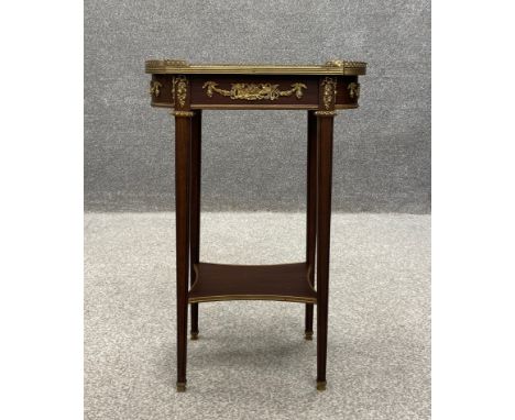 A French Empire style mahogany occasional or lamp table having a marquetry inlaid lobed top with a pierced brass gallery surr