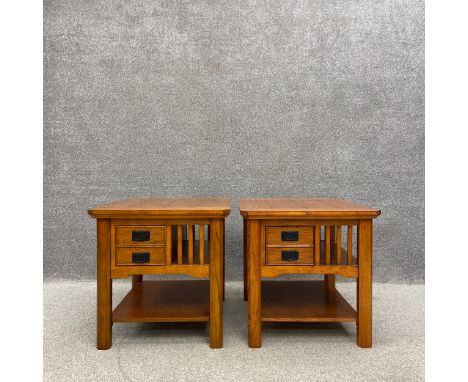A pair of contemporary oak side or bedside tables each having a square moulded top above a small drawer and a slatted bookshe