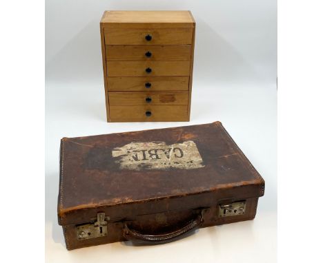 A mid century pine collector's chest of drawers along with small early 20th century leather travel or briefcase. H.28cm (larg
